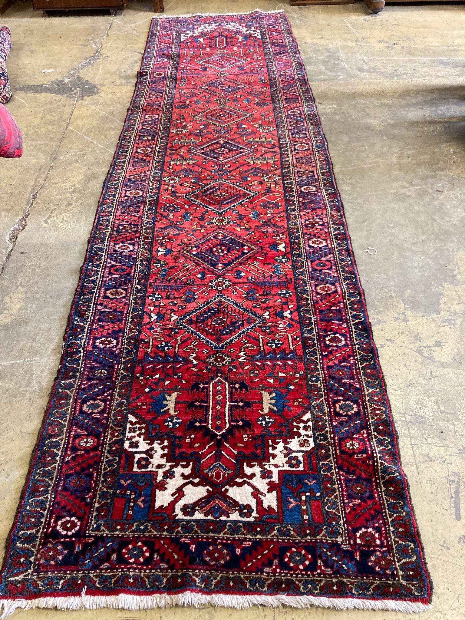 A North West Persian red ground hall carpet, 440 x 115cm